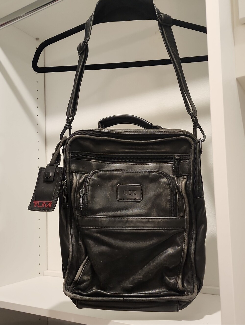 Tumi Black Leather Vertical Messenger Bag with Top Handle and Shoulder Strap